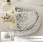 Cat sleeping in round plush gray pet bed with cozy faux fur lining indoors