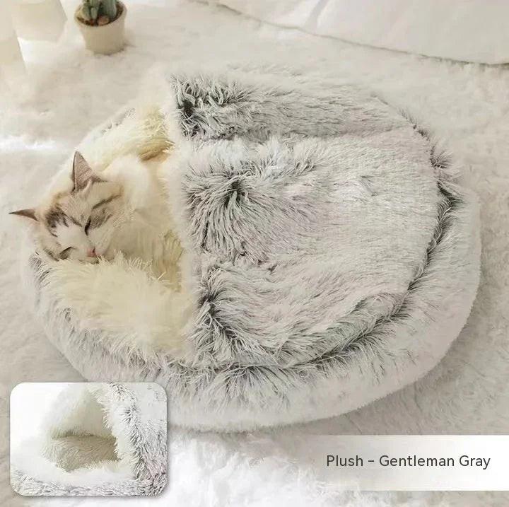 Cat sleeping in plush gray covered pet bed on soft white carpet