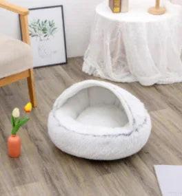 Plush white covered pet bed for cats and small dogs in cozy home setting