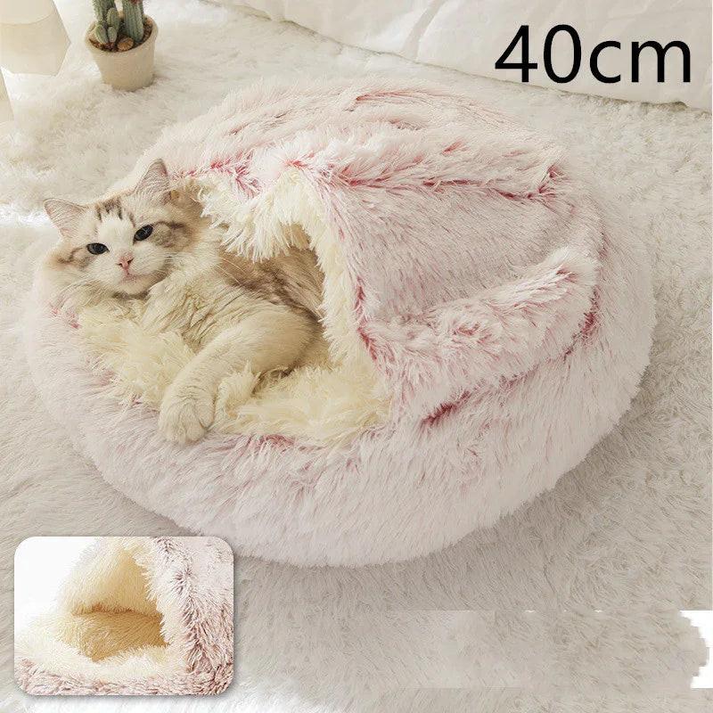 Fluffy cat in a soft pink and cream pet cave bed, 40cm, on a white rug