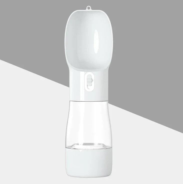 Portable dog water bottle with built-in dispenser and clear lower container on a gray background