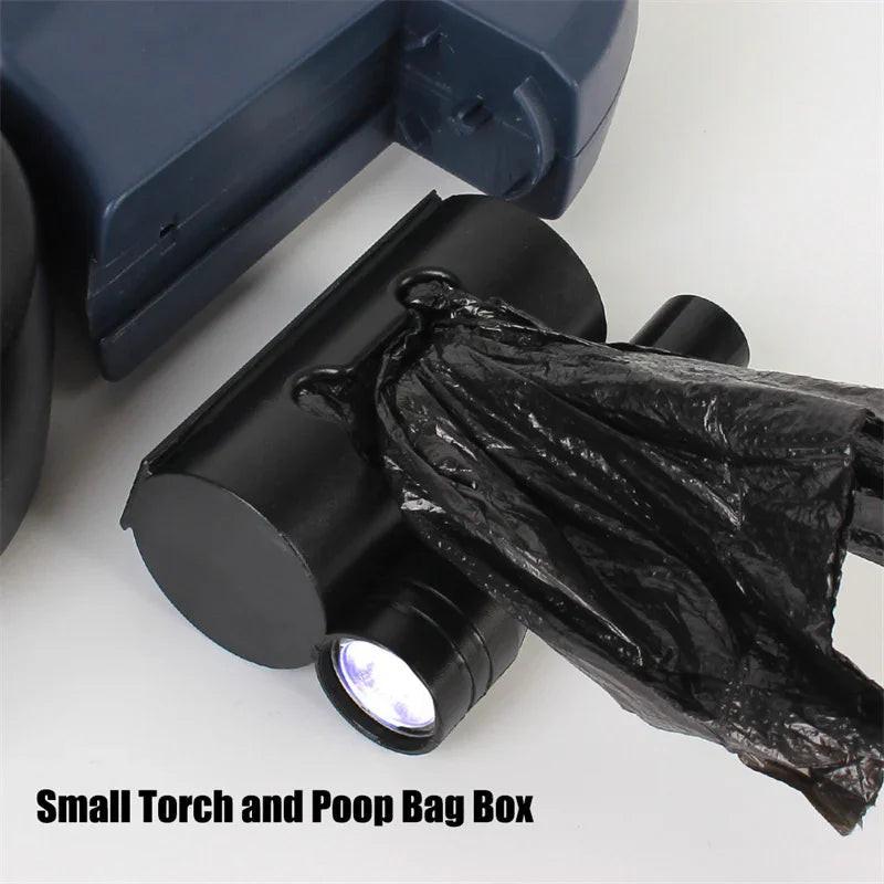 Black pet poop bag holder with built-in LED torch and waste bag partially dispensed.
