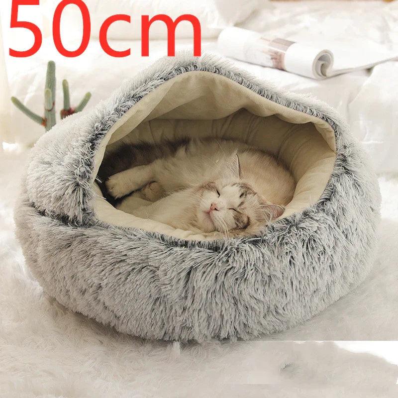 Cat sleeping in a cozy gray fluffy pet cave bed, 50cm, on a white rug