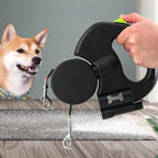 Retractable dual dog leash with ergonomic handle, two clips, and smiling dog indoors