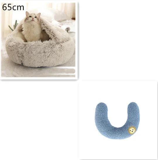 Fluffy cat in a soft, gray pet cave bed and a blue U-shaped pet neck pillow with a small patch.