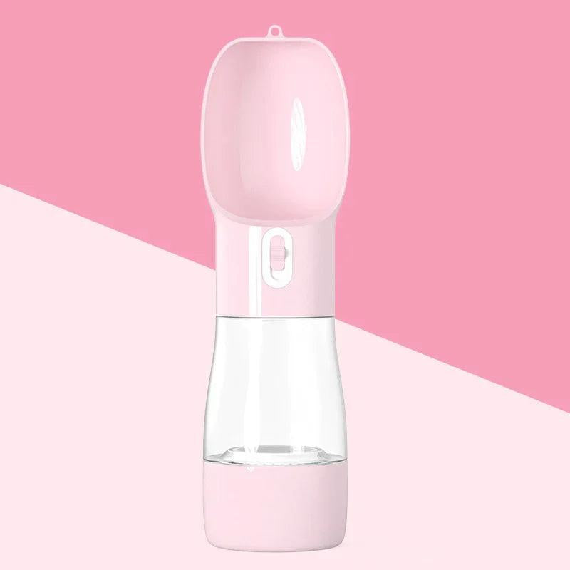 Pink portable pet water bottle with built-in drinking bowl on a pink background