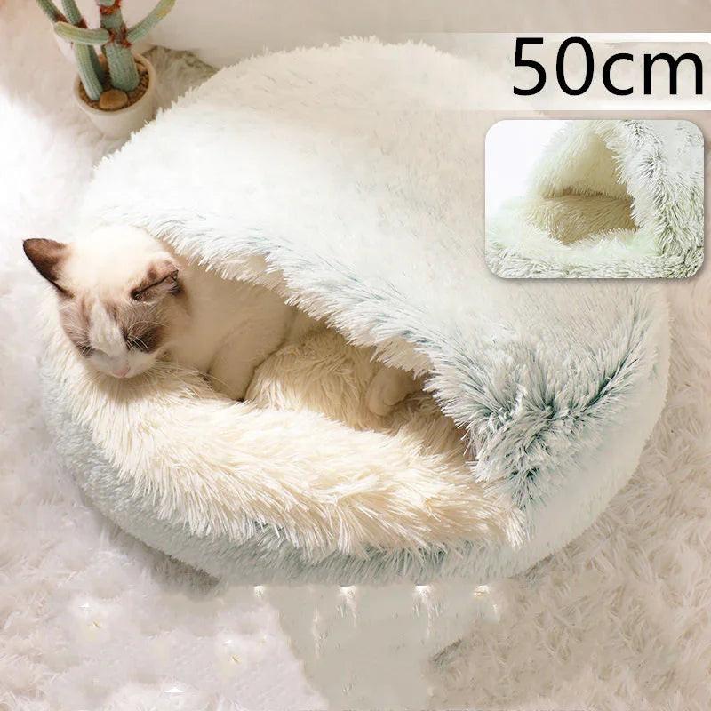 Cat sleeping in a round fluffy covered pet bed, soft white faux fur, 50cm size.