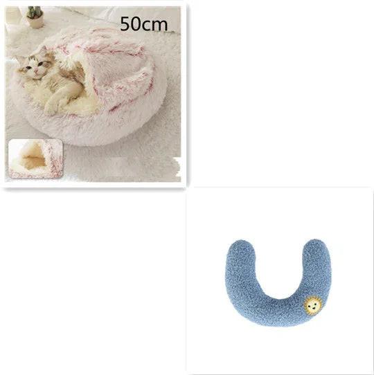 Cat in a fluffy pink covered pet bed and a blue U-shaped pet pillow with lion patch
