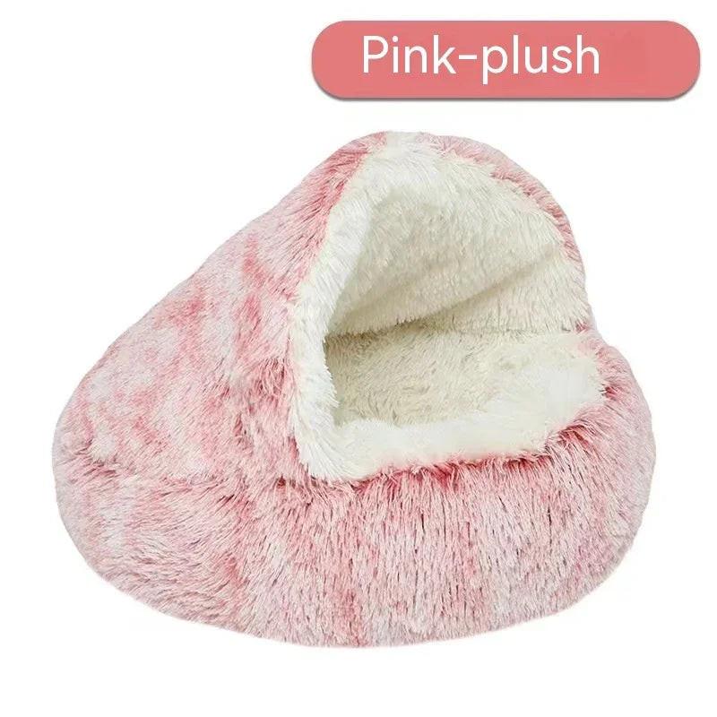 Pink plush cave-style pet bed with soft white lining for cats and small dogs