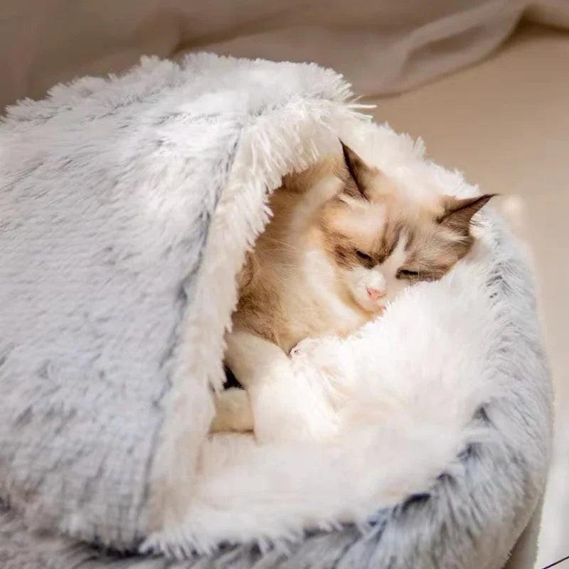 Fluffy cat resting inside soft, cozy faux fur pet bed in a neutral setting
