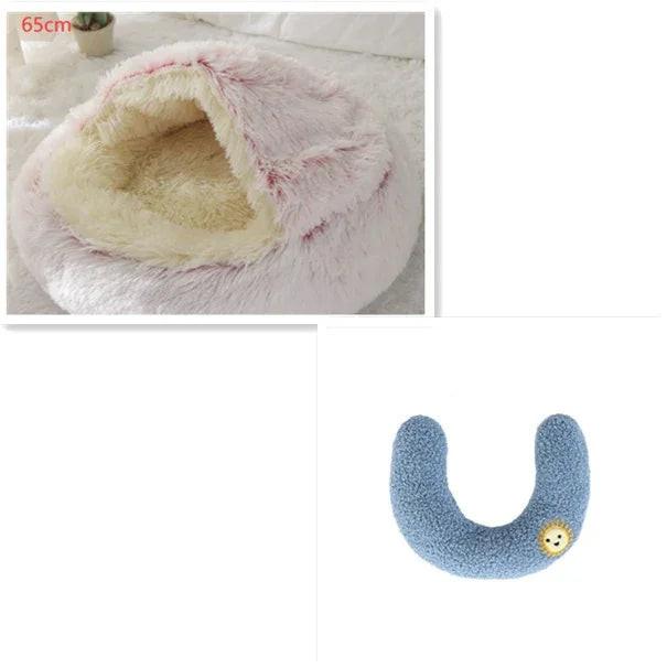 Fluffy pink pet cave bed and blue U-shaped dog toy on white background