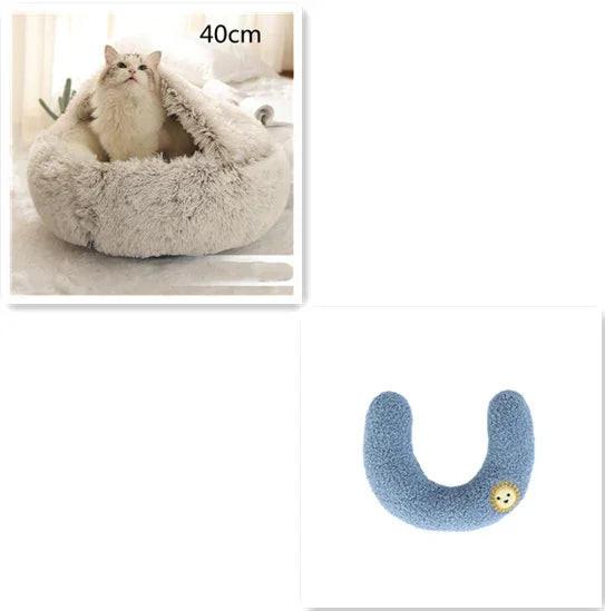 Fluffy white cat in a cozy 40cm pet bed next to a blue U-shaped plush cat toy.