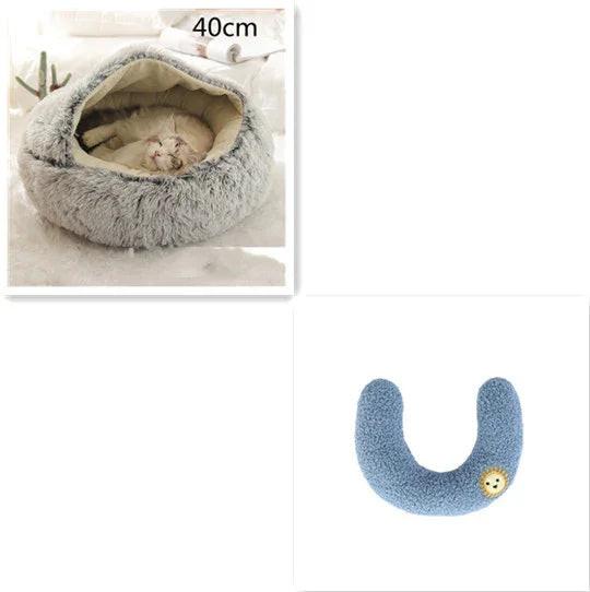 Fluffy gray cat bed with a sleeping cat, plus a blue U-shaped pet neck pillow with lion patch.