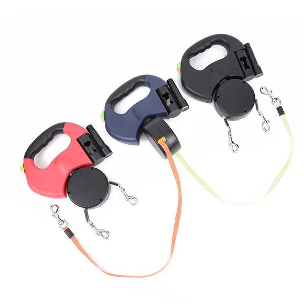 Three retractable dual dog leashes with ergonomic handles in red, blue, and black on white background
