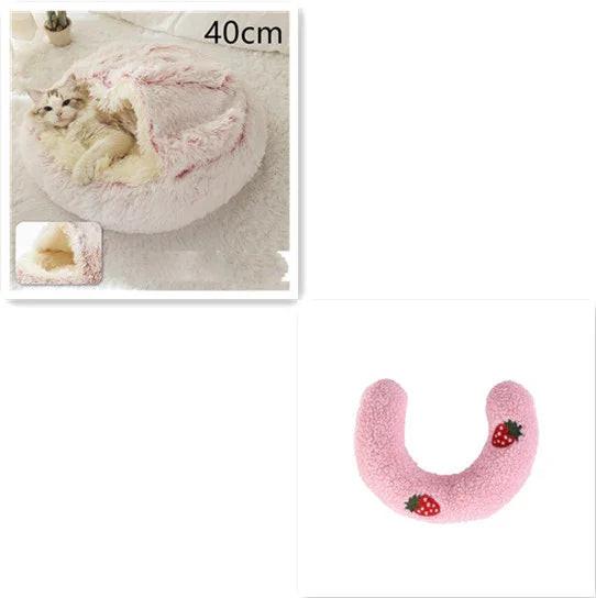 Cozy pink cat bed with hood, plush donut shape, and a pink U-shaped pet pillow with strawberry design.